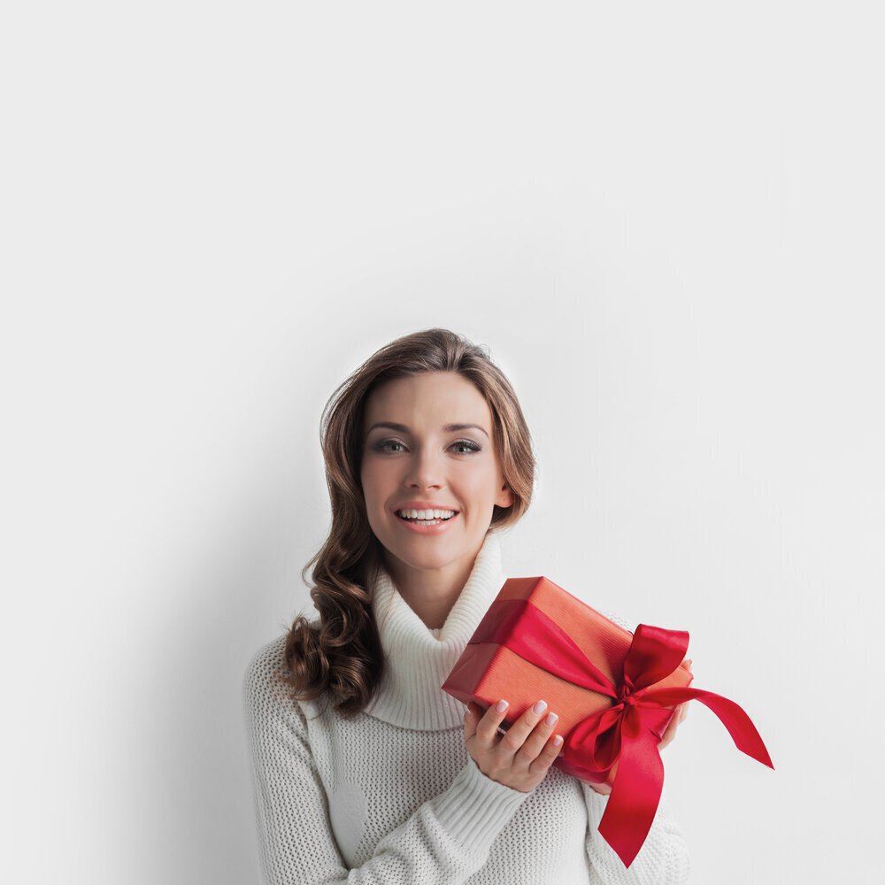 woman holding up red skincare gift