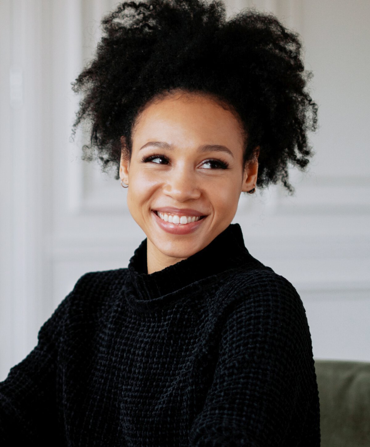 Smiling woman with curly hair up