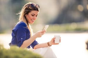 Woman on phone smiling after kybella