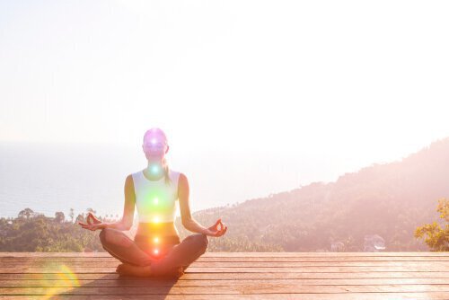 person sitting cross legged with fingers touching in meditative pose