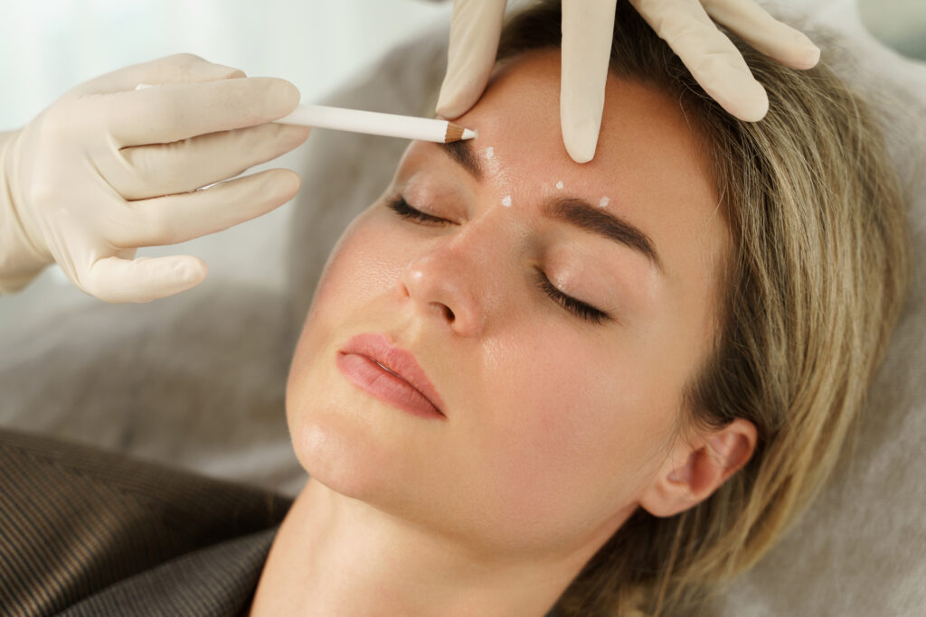 Doctor making marks on client's face before filler injection Dysport in Short Hills, NJ