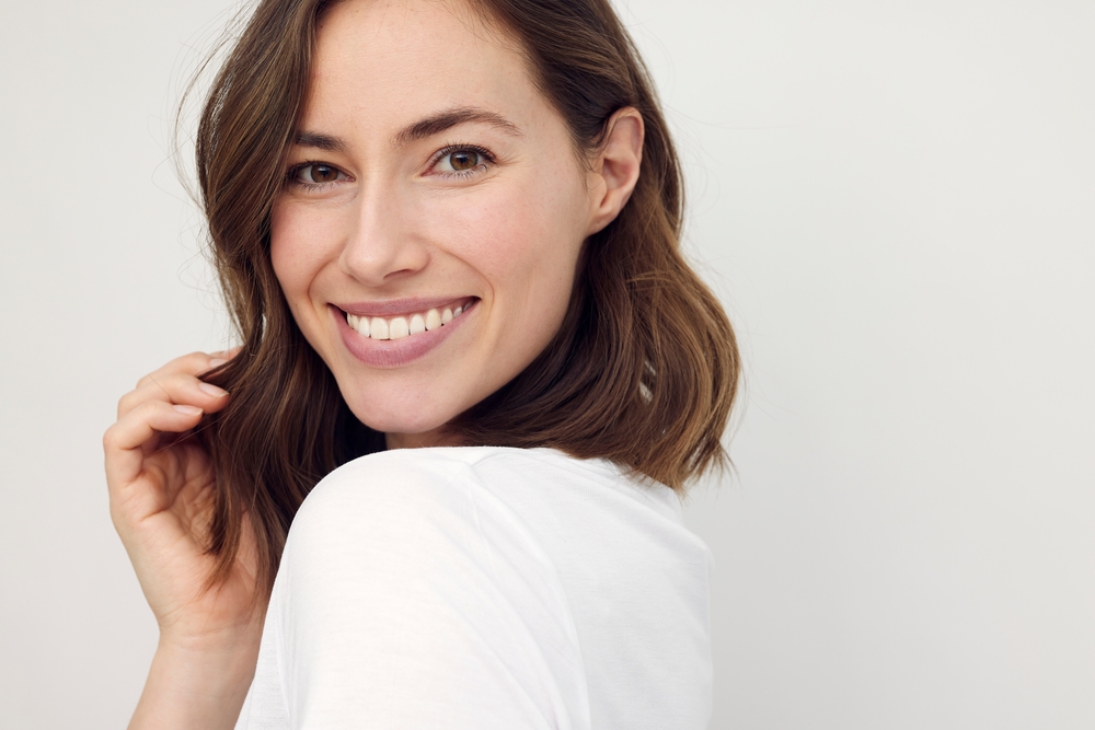 Beautiful woman smiling with youthful looking skin after 8 point facelift
